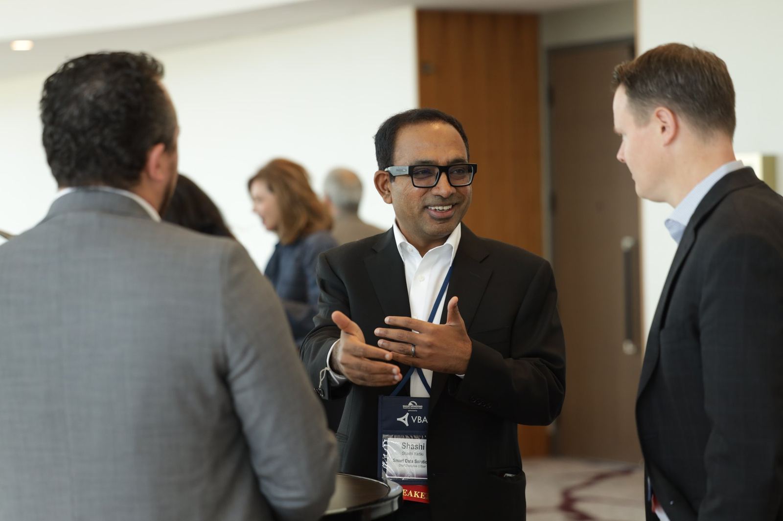 Two professionals in conversation during a networking break