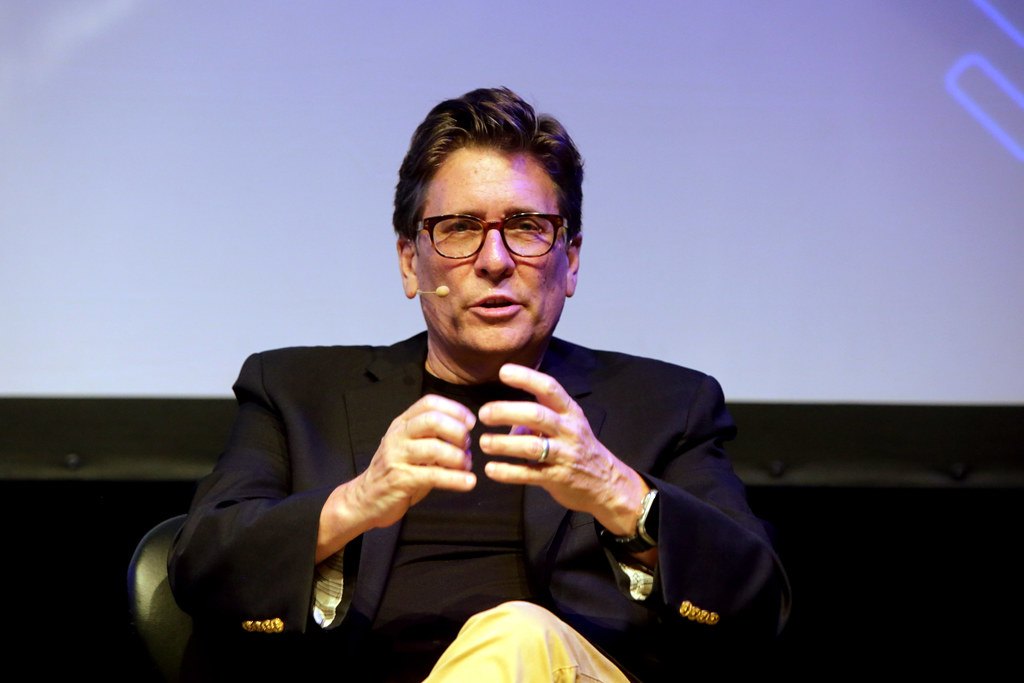 Panelist gesturing while speaking on a session stage