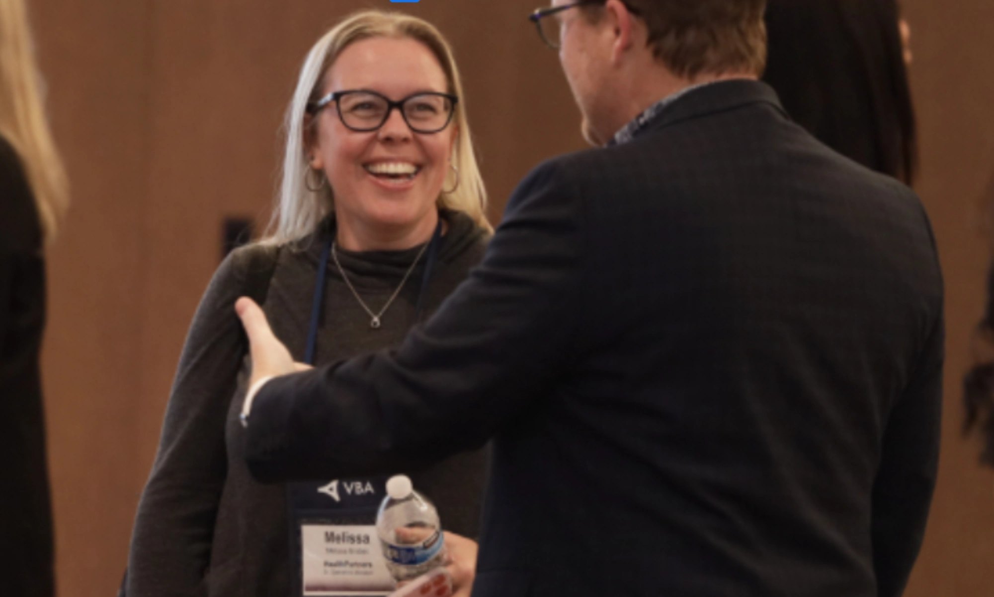 Two attendees in friendly conversation at a Smart Horizons event